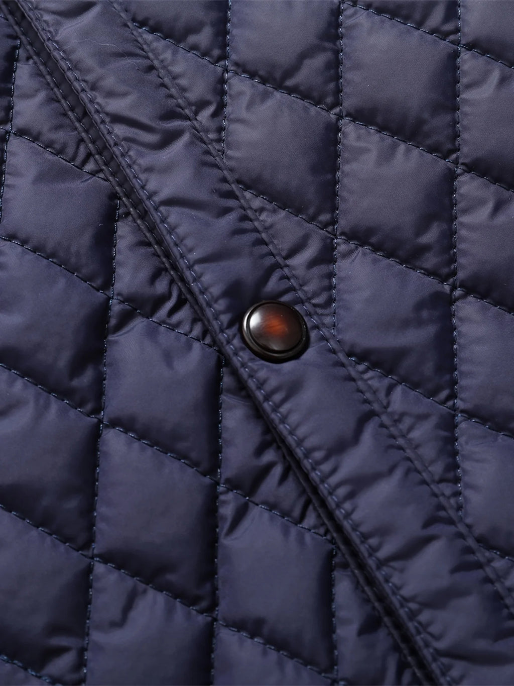 Men's black quilted jacket, button and quilting detail