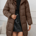 Women's reddish brown hooded longline puffer coat with full-length zip