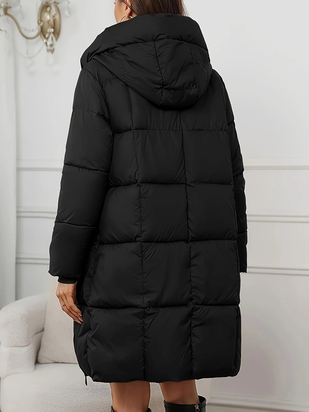 Women's black hooded longline puffer coat with full-length zip