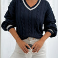 Women's navy cable-knit v-neck sweater for layering, with ribbed trim