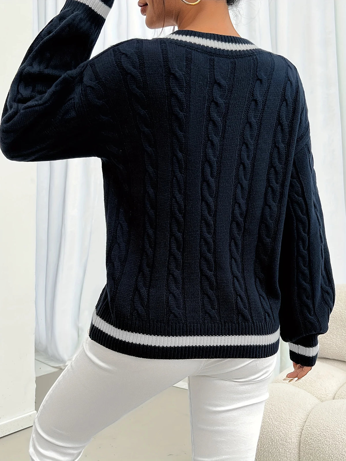 Women's navy cable-knit v-neck sweater for layering, with ribbed trim