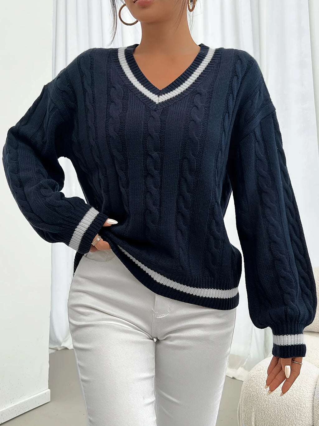 Women's navy cable-knit v-neck sweater for layering, with ribbed trim
