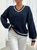 Women's navy cable-knit v-neck sweater for layering, with ribbed trim
