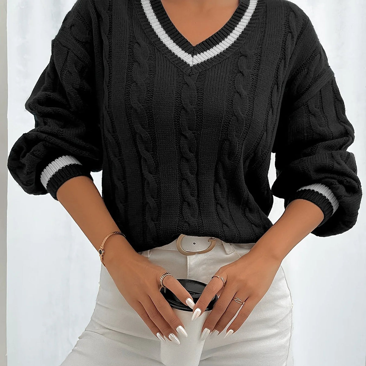 Women's black cable-knit v-neck sweater for layering, with ribbed trim