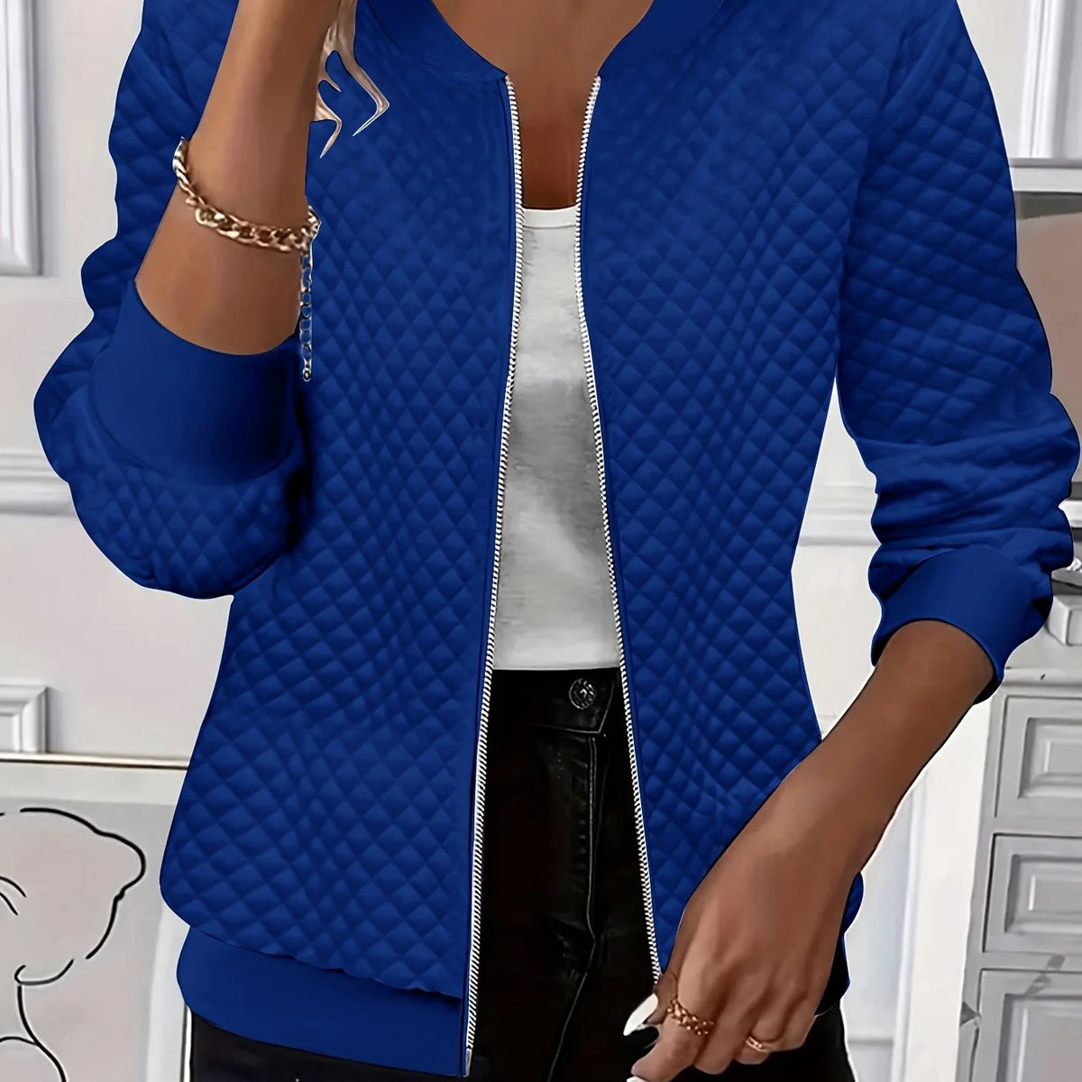 Women's blue quilted bomber jacket with ribbed collar
