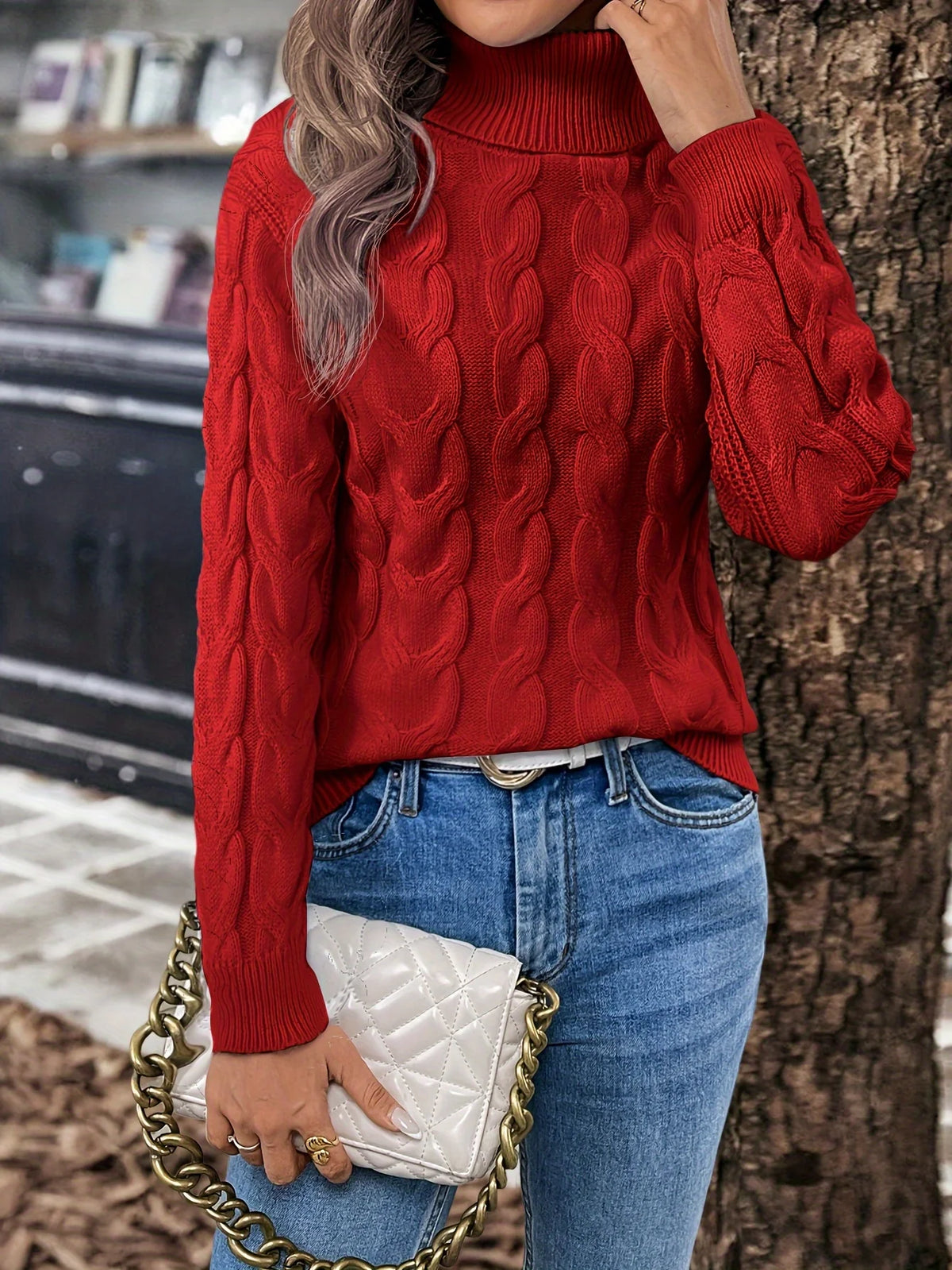 Women's red chunky cable knit turtleneck sweater, outdoor look