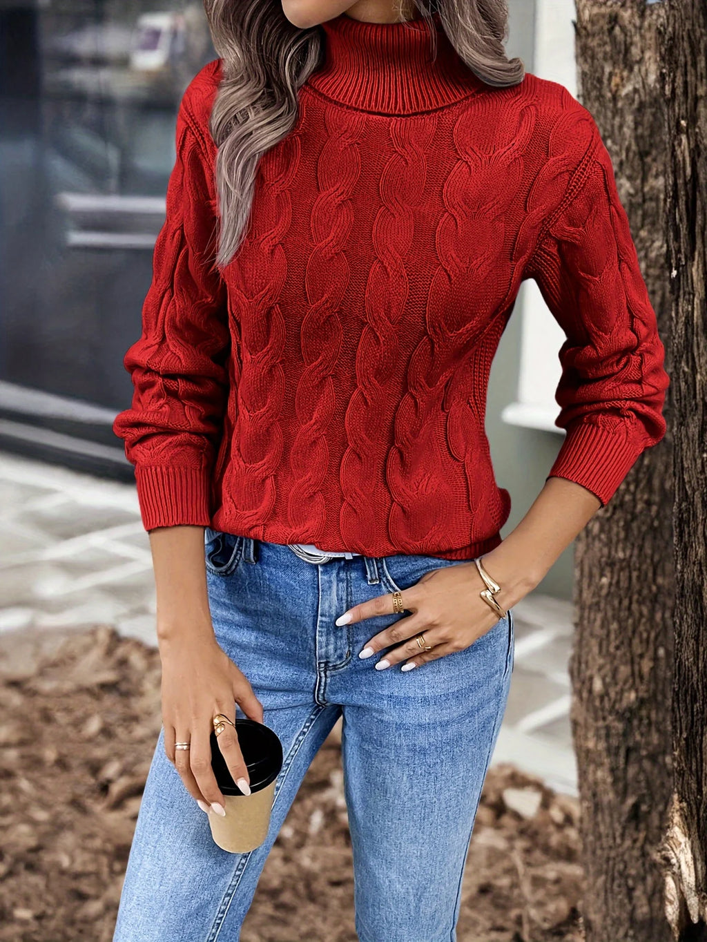 Women's black chunky cable knit turtleneck sweater, front view