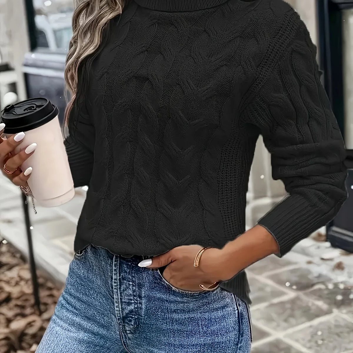 Women's black cable knit turtleneck sweater, front view