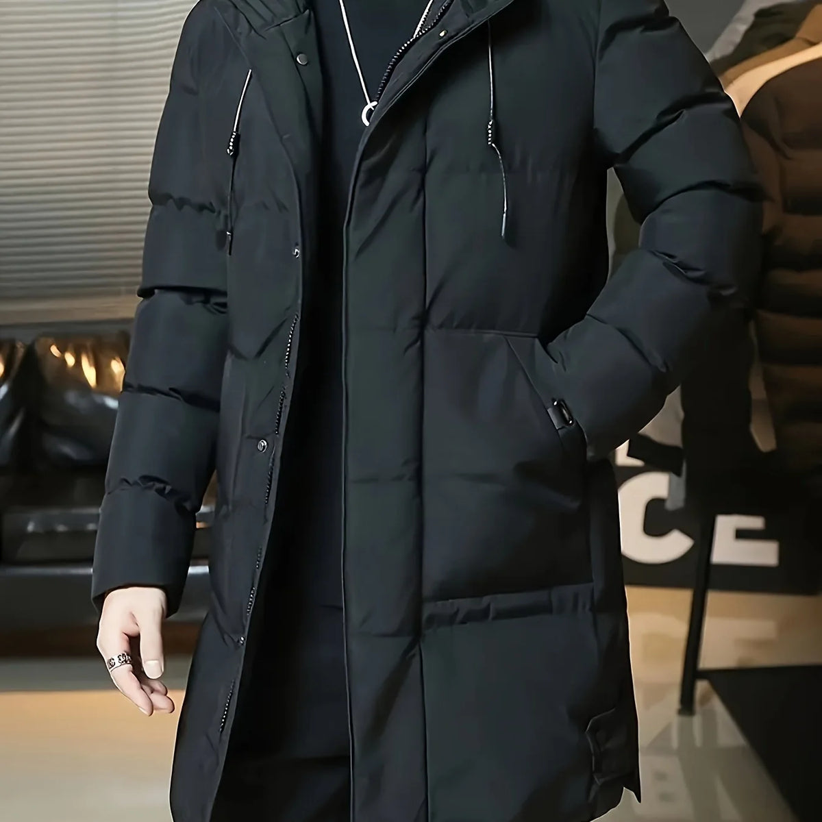 Men's black hooded longline puffer coat, chest pocket detail