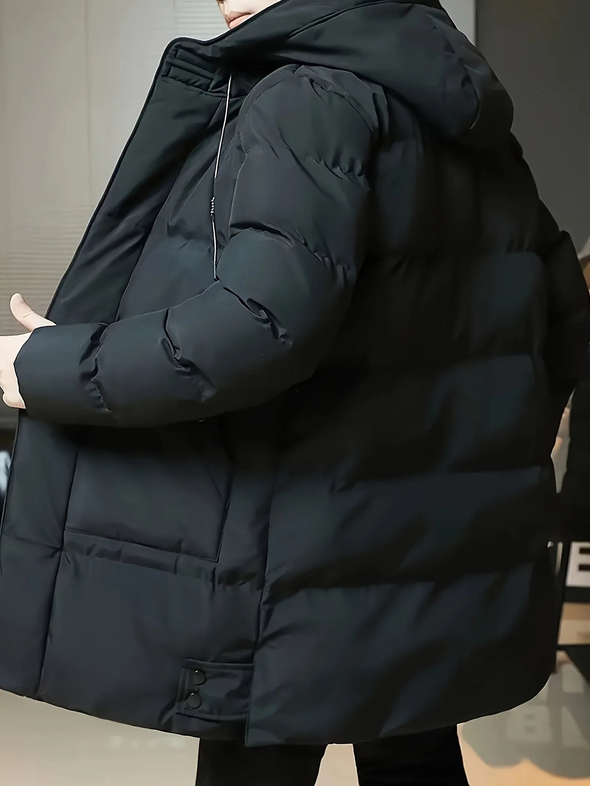 Men's black hooded longline puffer coat, side view with hood