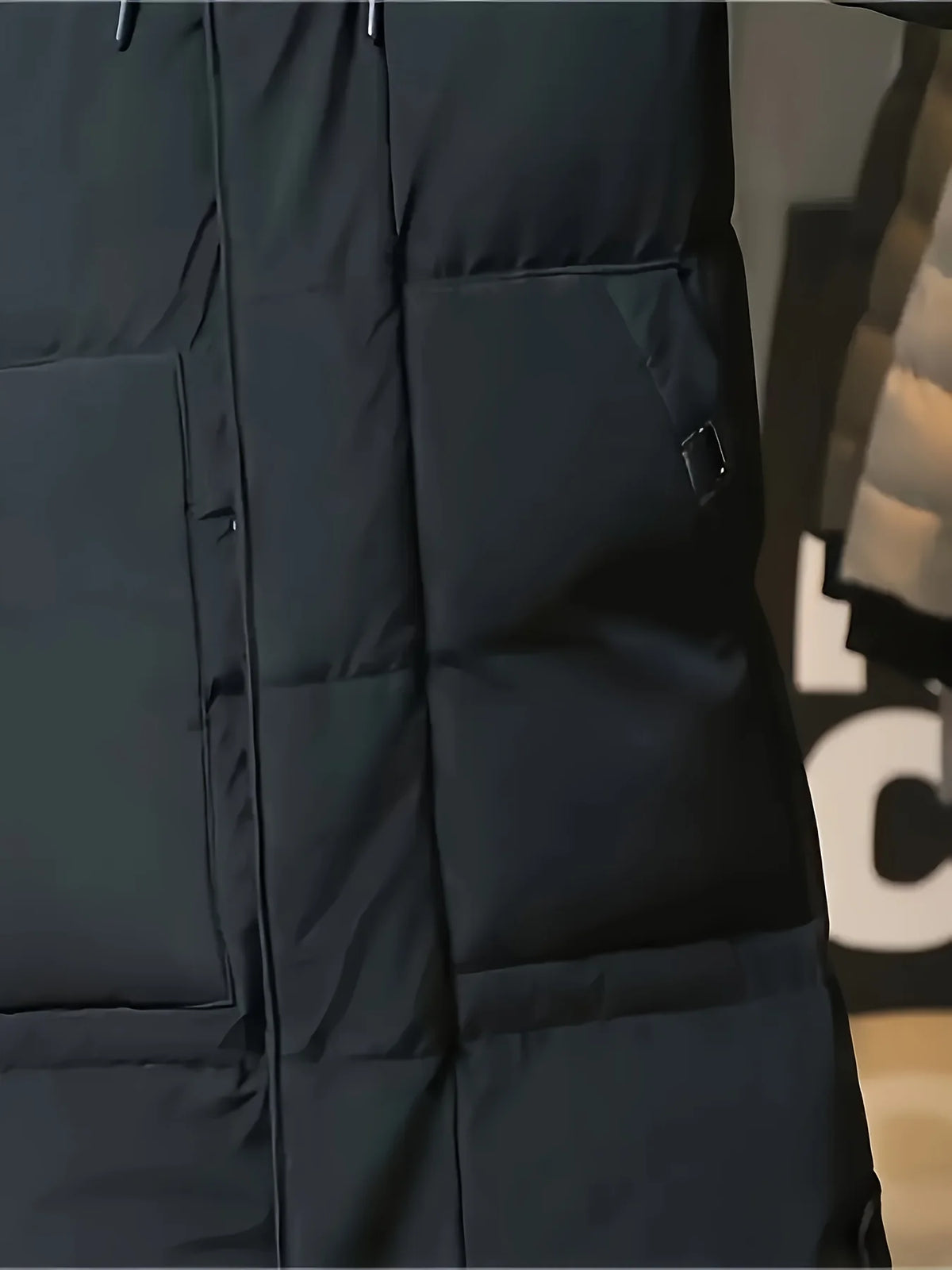 Men's black hooded longline puffer coat, side pocket and hem detail