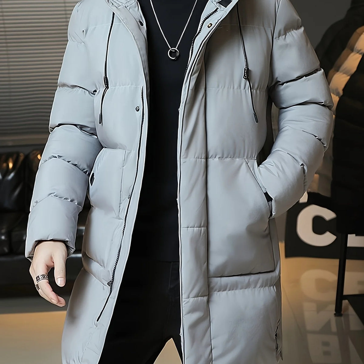 Men's gray hooded longline puffer coat, zipped front view