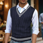 Men's navy cable knit sweater vest with striped V-neck trim