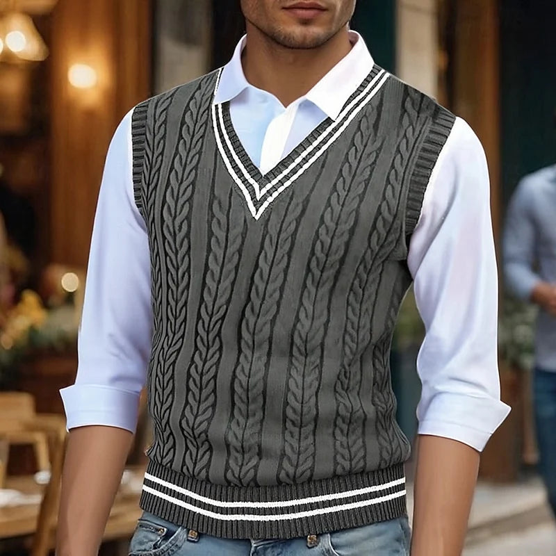 Men's dark gray cable knit sweater vest with striped V-neck trim