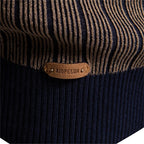 Close-up of leather brand patch on men's mock neck sweater cuff