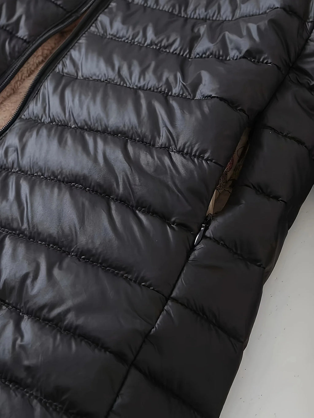 Women's black quilted longline puffer coat with relaxed silhouette