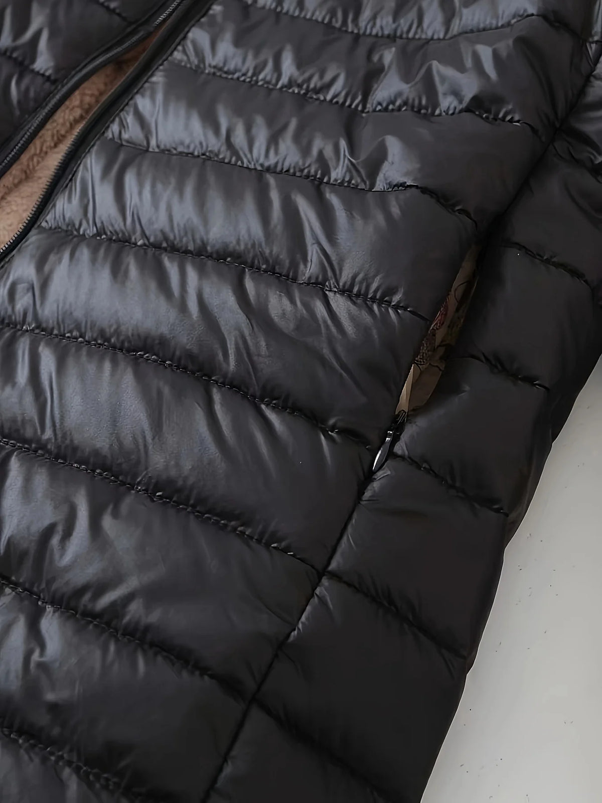 Women's black quilted longline puffer coat with relaxed silhouette