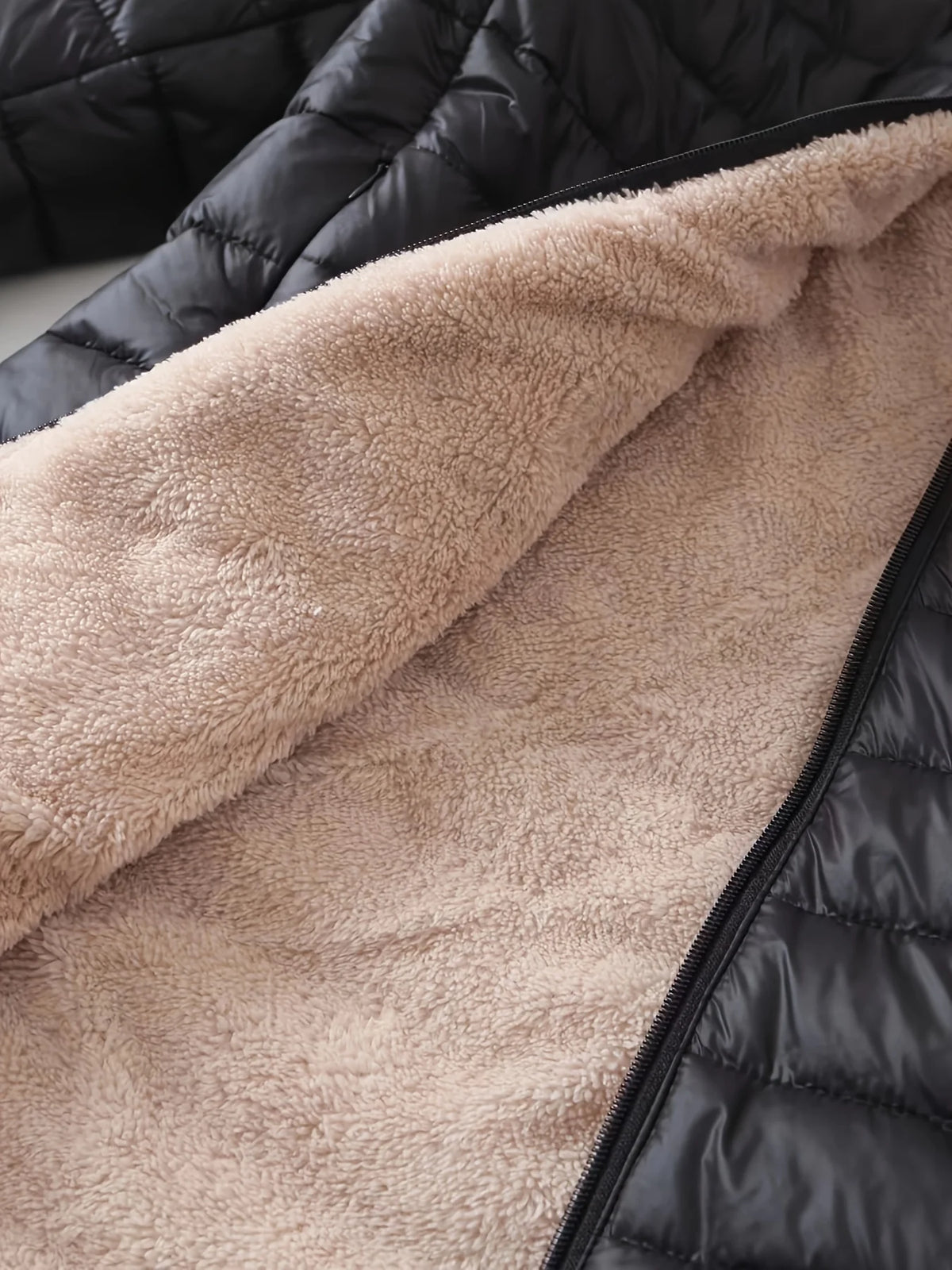 Women's black quilted longline puffer coat with relaxed silhouette