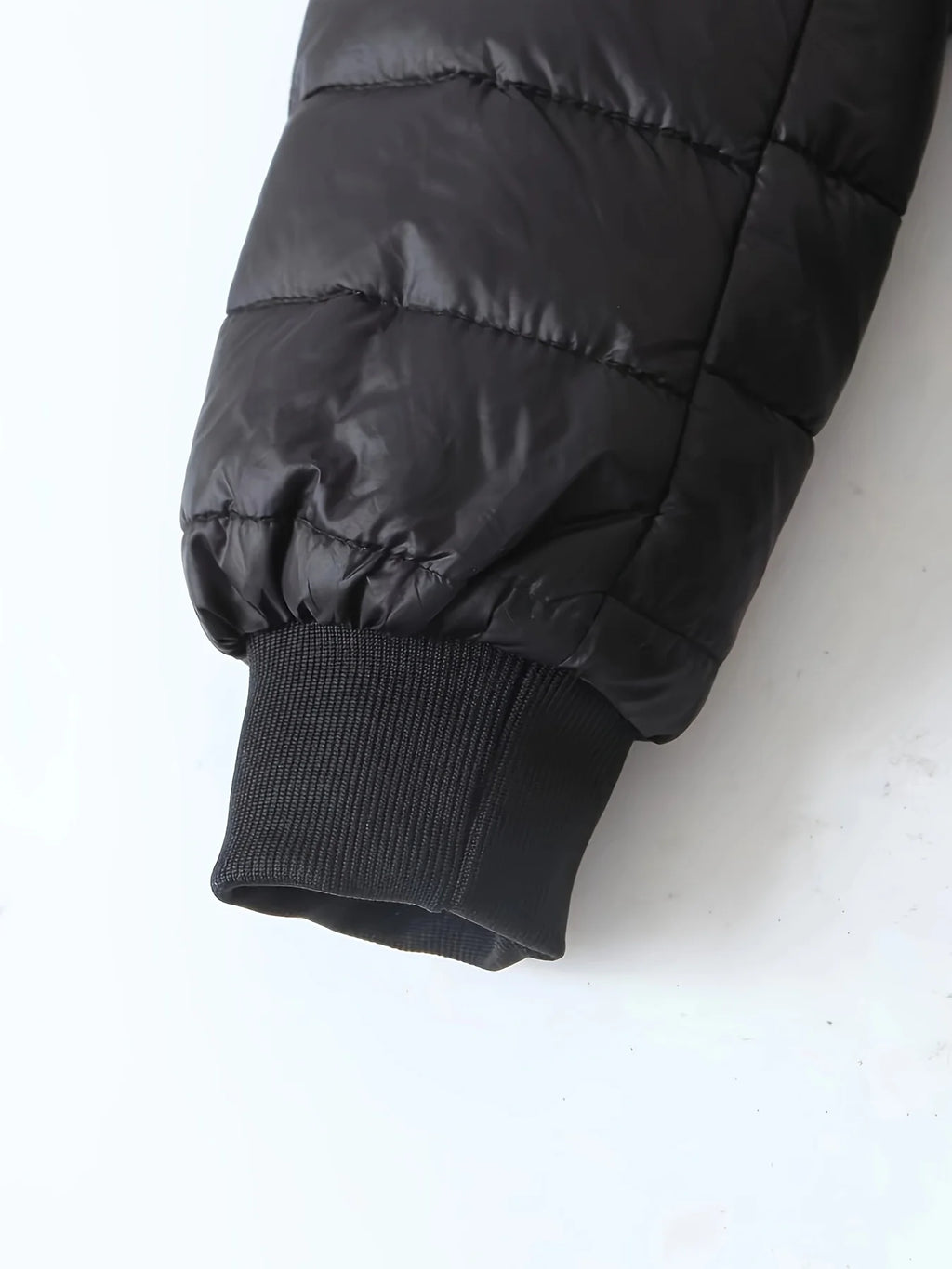 Women's black quilted longline puffer coat with relaxed silhouette
