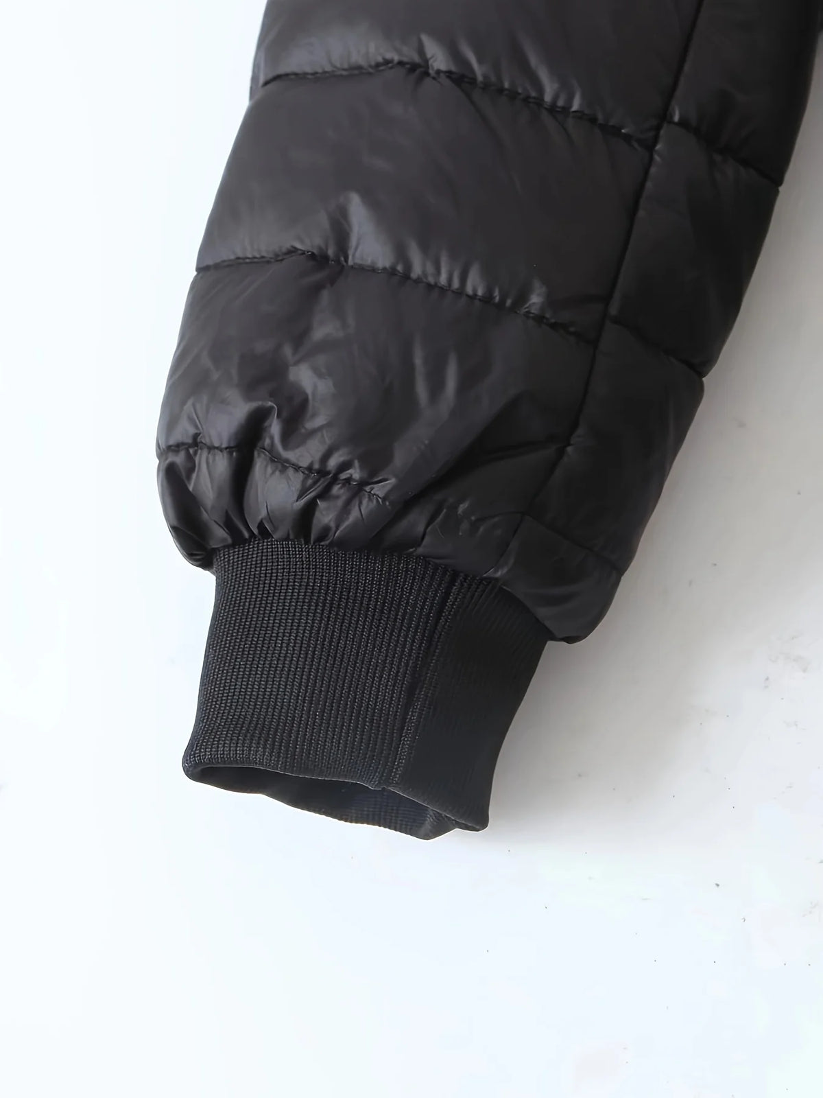 Women's black quilted longline puffer coat with relaxed silhouette