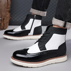 Men's black wingtip ankle boots styled with rolled denim