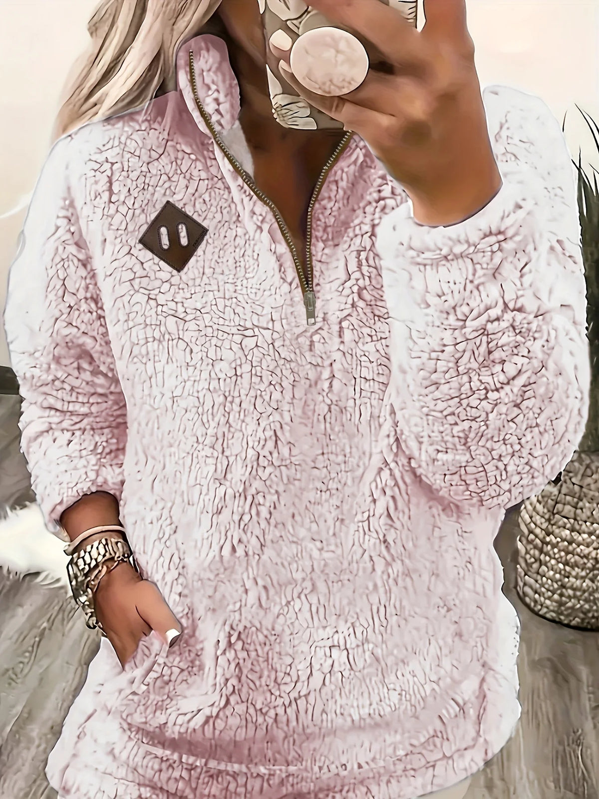 Women's pale pink sherpa half-zip pullover with stand collar