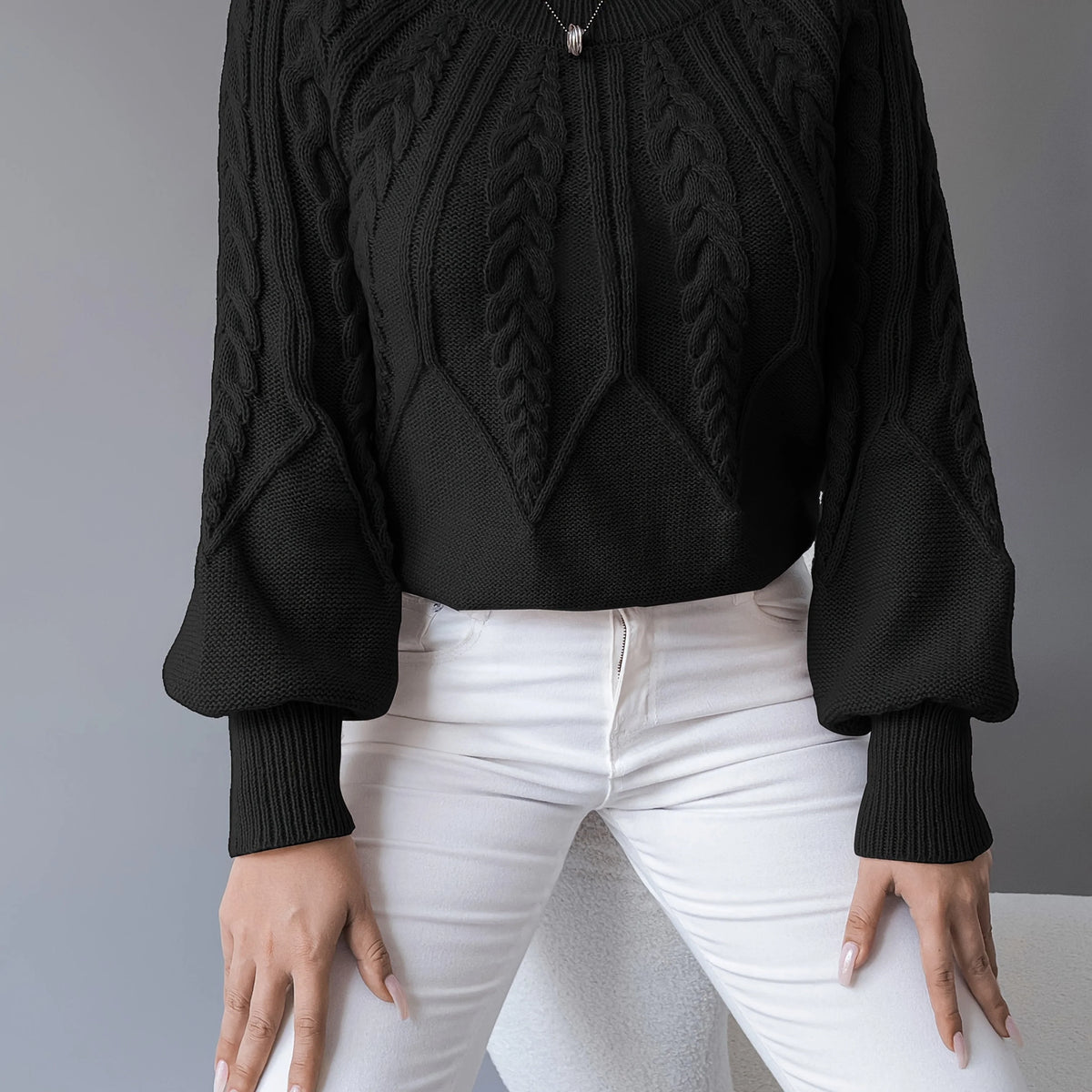 Women's black cable knit lantern sleeve sweater, close-up