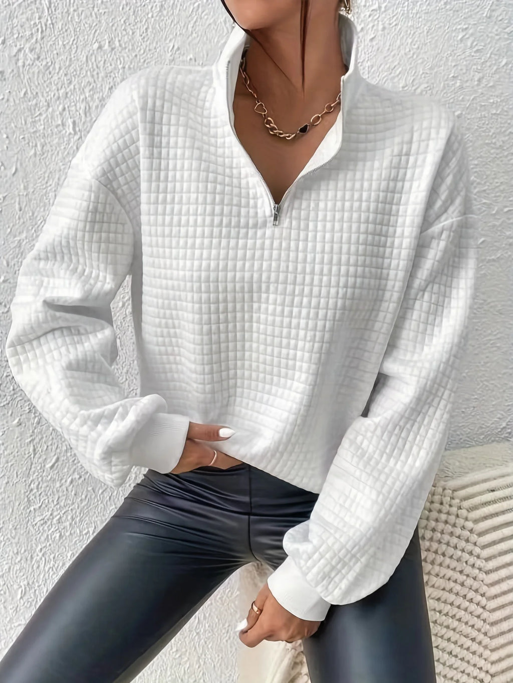 Women's white relaxed-fit quarter-zip sweater with ribbed hem