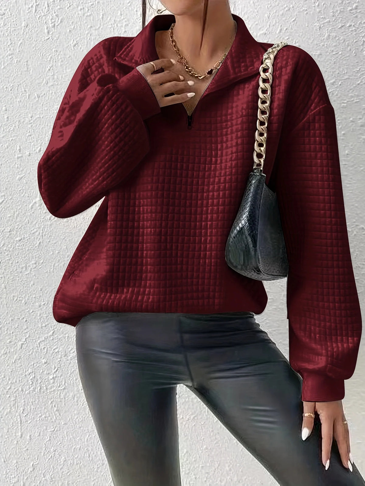 Women's deep red relaxed-fit quarter-zip sweater with ribbed hem