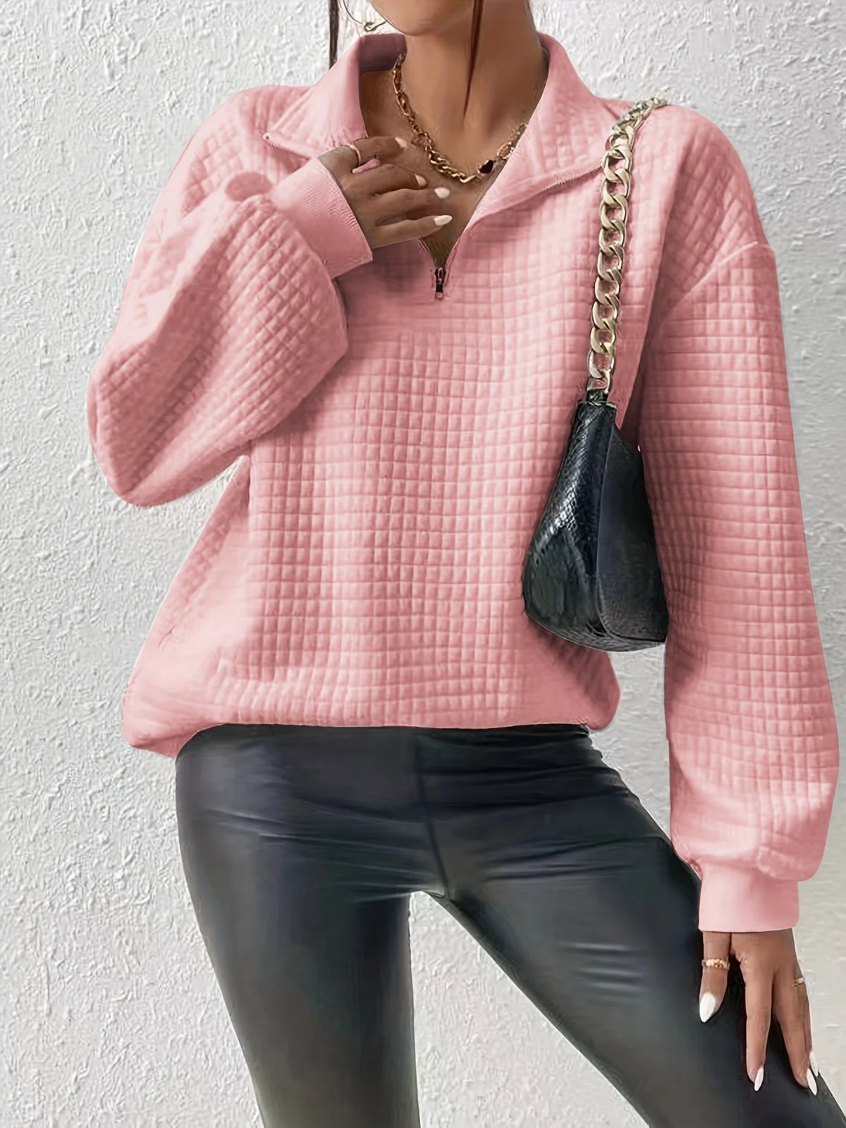 Women's pink relaxed-fit quarter-zip sweater with ribbed hem