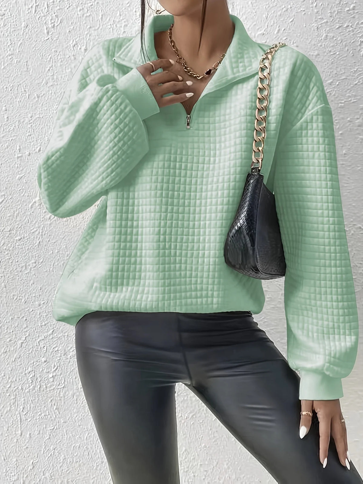 Women's light green relaxed-fit quarter-zip sweater with ribbed hem