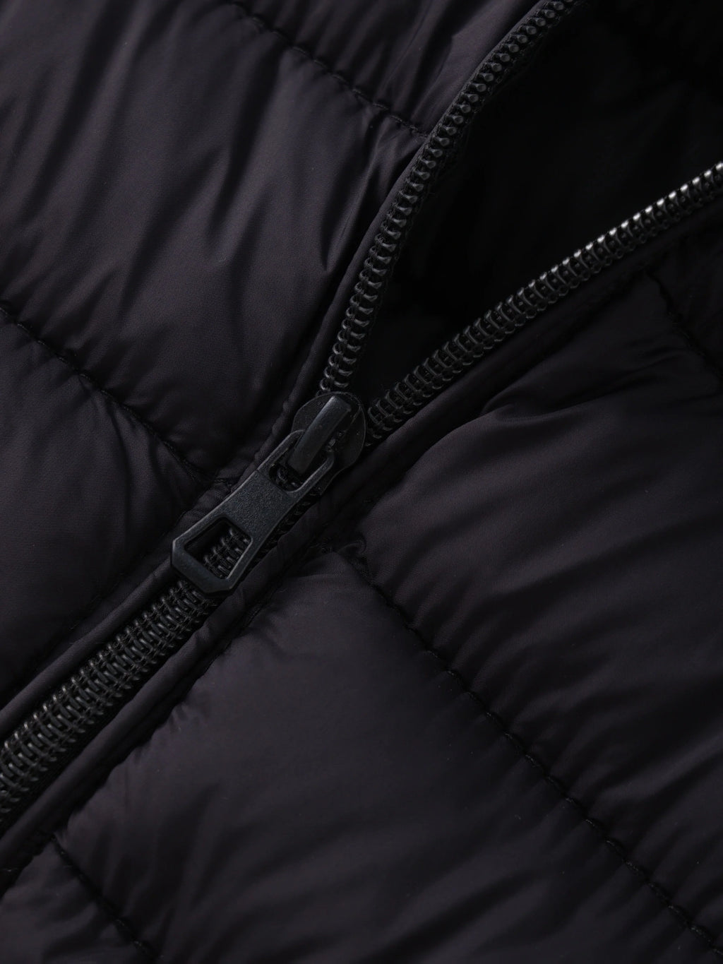 Women's black cropped puffer jacket zipper detail