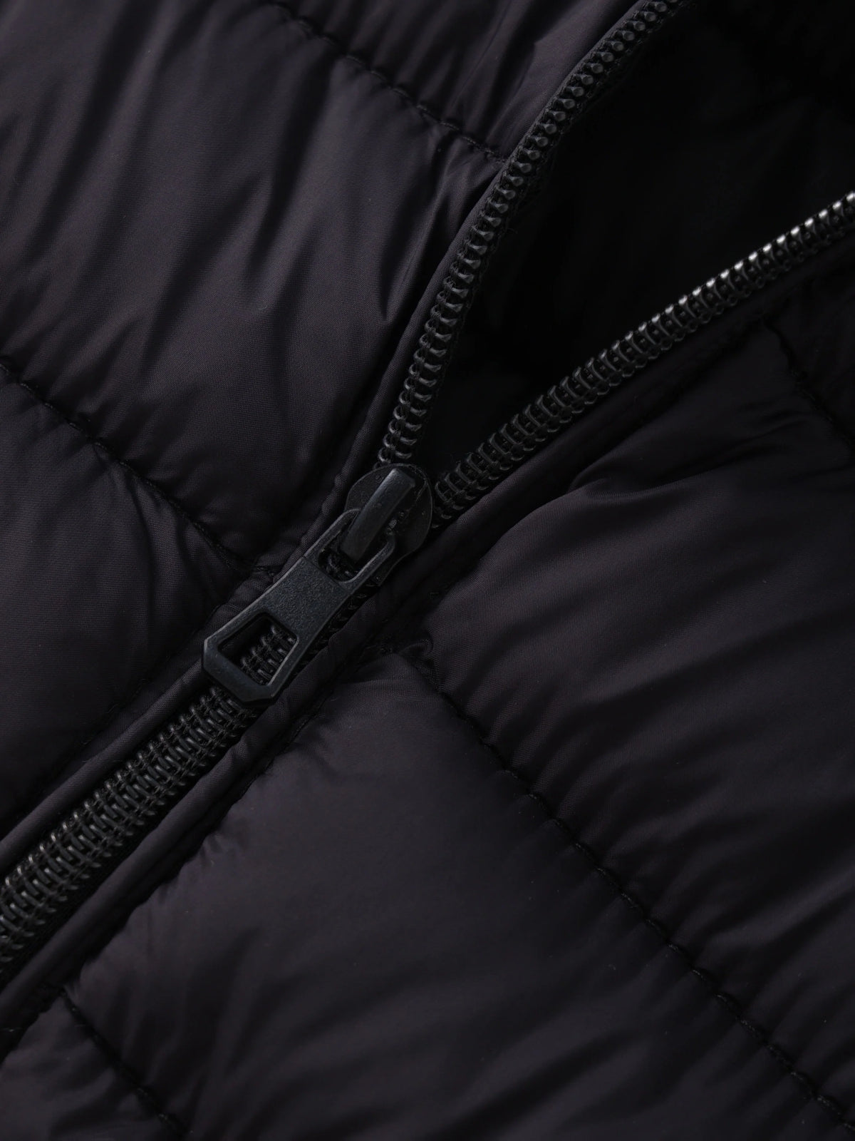 Women's black cropped puffer jacket zipper detail
